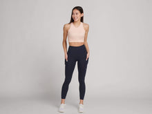 Load image into Gallery viewer, woman in navy high waisted leggings and peach crop top
