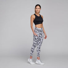 Load image into Gallery viewer, woman wearing floral leggings and black crop tank
