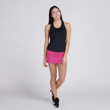 Load image into Gallery viewer, woman wearing pink tennis skirt and black top
