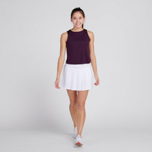 Load image into Gallery viewer, Woman in plum top and white pleated tennis skirt
