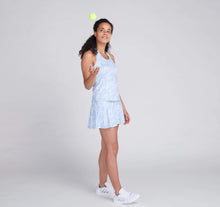Load image into Gallery viewer, woman throwing tennis ball wearing blue printed tennis outfit
