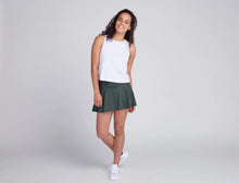 Load image into Gallery viewer, woman wearing white tank top and green tennis skirt
